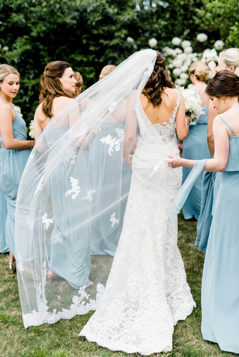 bride wearing mom's long veil with lace