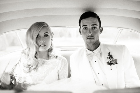 bride and groom in a vintage car