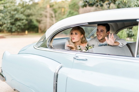 bride and groom in a blue vintage car