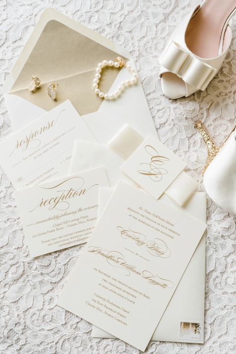 Gold and white wedding invitations. Coordination by Kast Events at the Chapel Hill Carriage House. Photo by Caroline Lima.