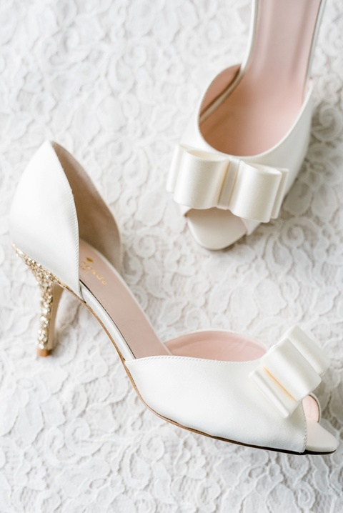 White and gold Kate Spade wedding shoes. Coordination by Kast Events at the Chapel Hill Carriage House. Photo by Caroline Lima.