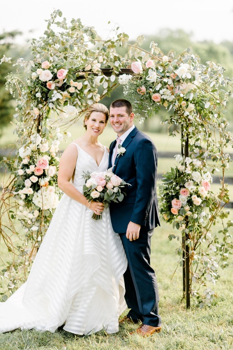 Outdoor farm wedding in Richmond VA coordinated by Make It Posh Events. Flowers by Petals and Twigs. Hayley Paige stripped dress. Photo by Caroline Lima.