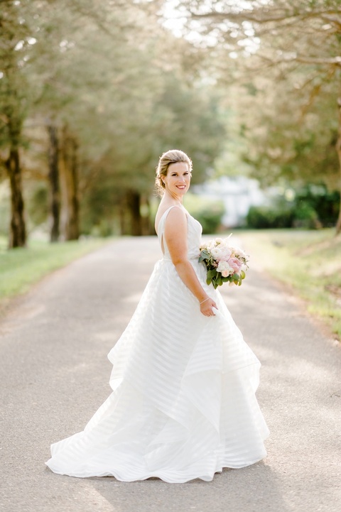 Outdoor farm wedding in Richmond VA coordinated by Make It Posh Events. Flowers by Petals and Twigs. Hayley Paige striped dress. Photo by Caroline Lima.