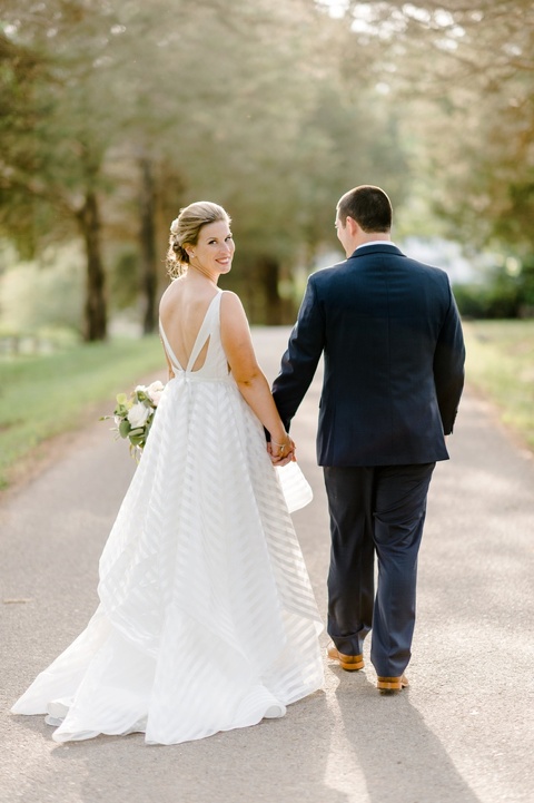 Outdoor farm wedding in Richmond VA coordinated by Make It Posh Events. Bride and groom portraits. Flowers by Petals and Twigs. Hayley Paige striped dress. Photo by Caroline Lima.