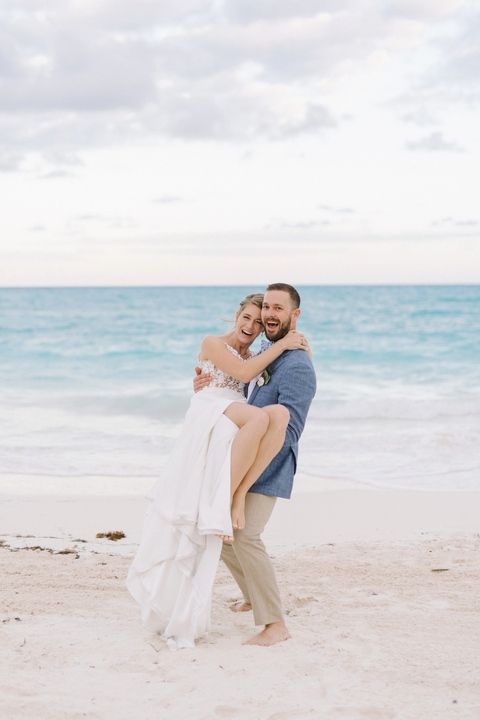 groom carrying a bride at the grand isle resort exuma wedding