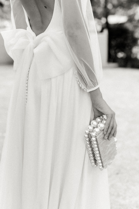 bride wearing kelly faetanini sophie gown and cult gaia clutch
